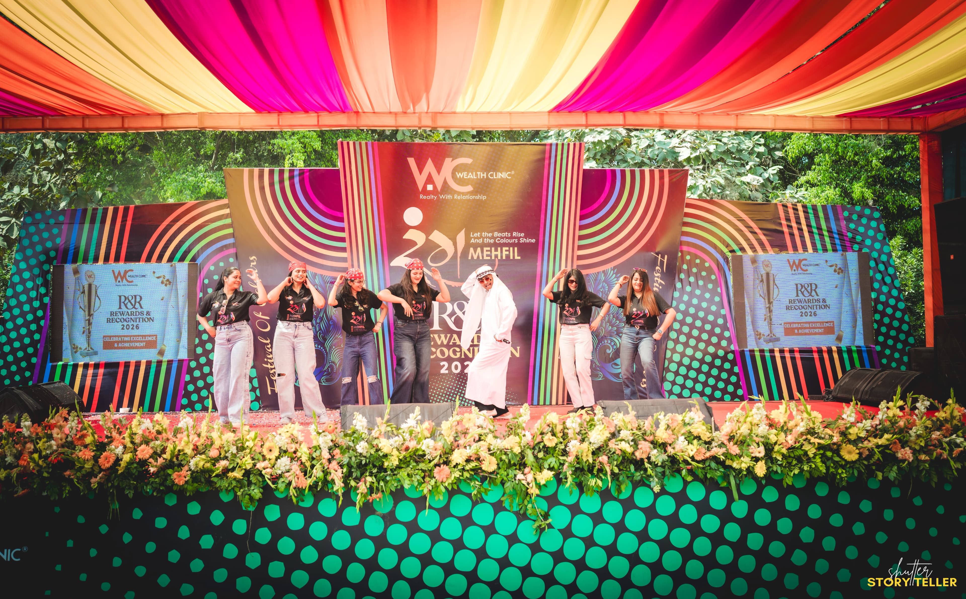 Wealth Clinic team seated in front of a branded screen