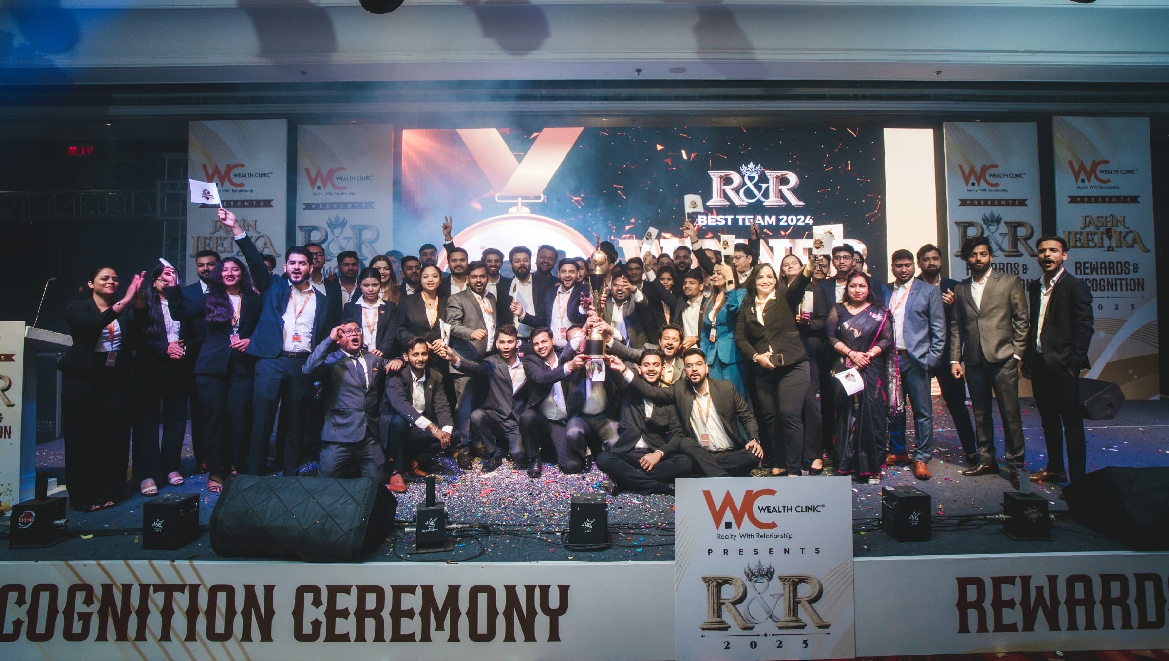 Wealth Clinic team celebrating on stage at the R&R awards night