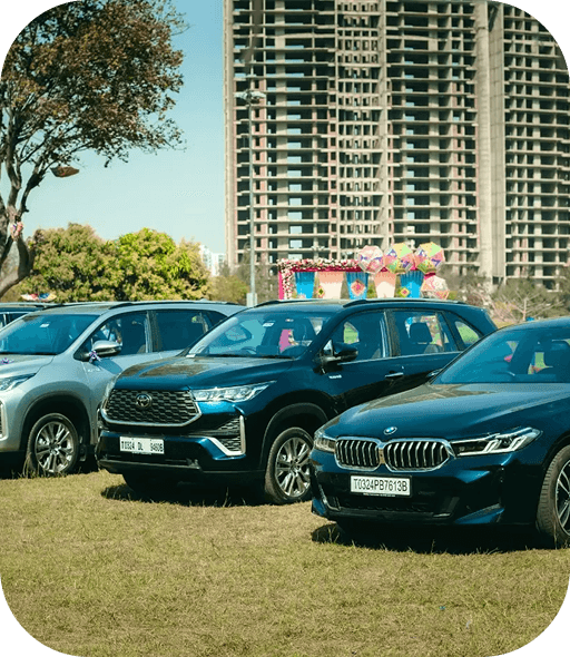 Row of company reward cars parked with a residential skyline behind